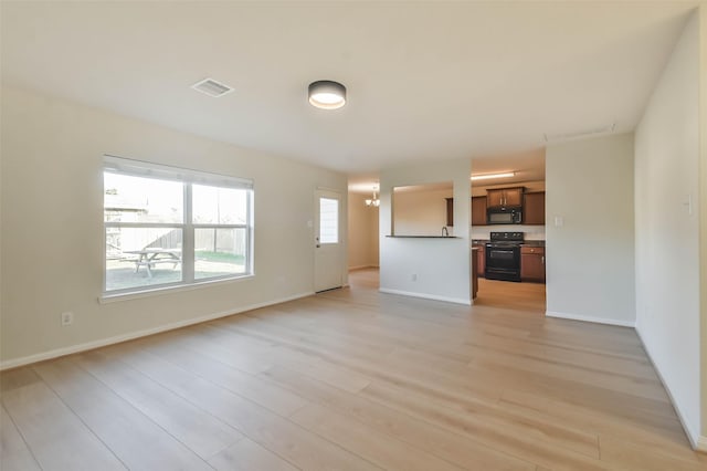 unfurnished living room with light wood-type flooring