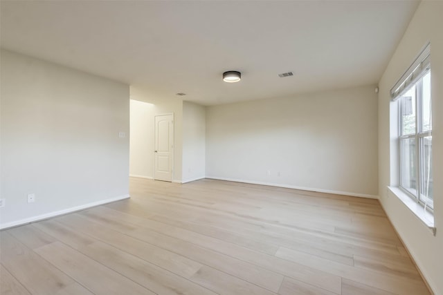 spare room featuring light hardwood / wood-style flooring