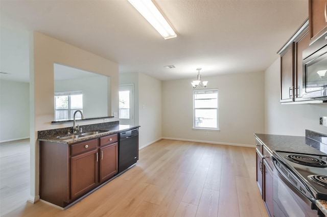 kitchen with black appliances, sink, decorative light fixtures, light hardwood / wood-style flooring, and a notable chandelier