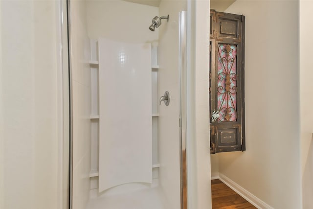 bathroom featuring a shower and wood-type flooring