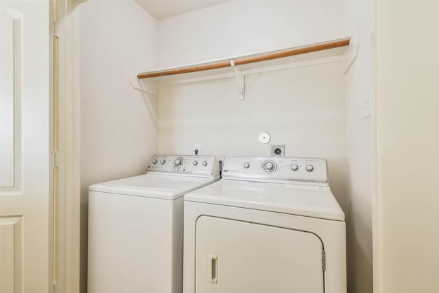 clothes washing area with washer and dryer