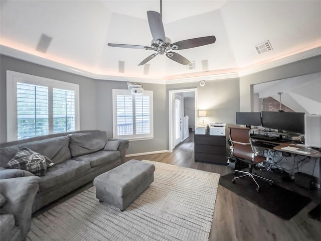 home office featuring a tray ceiling, lofted ceiling, ceiling fan, and dark hardwood / wood-style floors