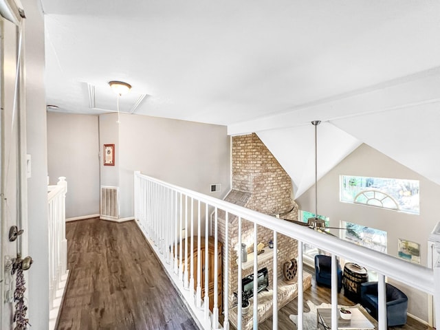 hall featuring dark hardwood / wood-style floors and lofted ceiling