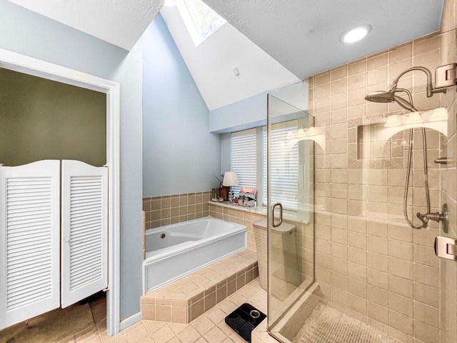 bathroom with tile patterned floors, lofted ceiling with skylight, and plus walk in shower