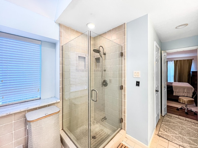 bathroom featuring tile patterned floors and a shower with shower door