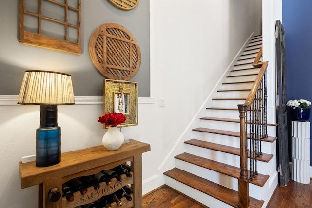 stairs featuring hardwood / wood-style flooring