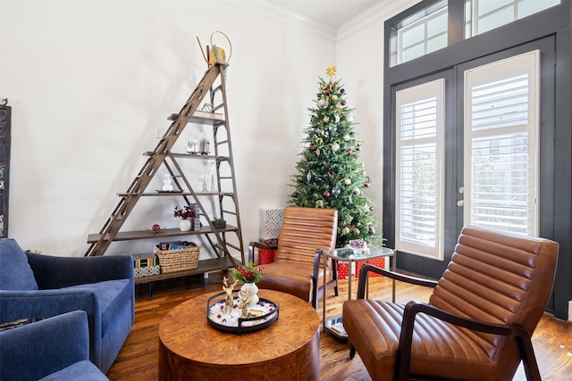 sitting room featuring hardwood / wood-style floors, plenty of natural light, and crown molding