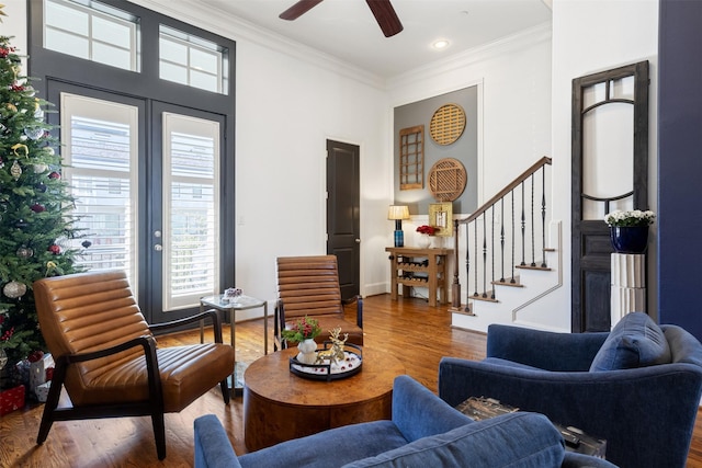 sitting room featuring ceiling fan, wood-type flooring, and crown molding