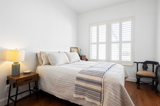 bedroom featuring dark hardwood / wood-style floors and multiple windows