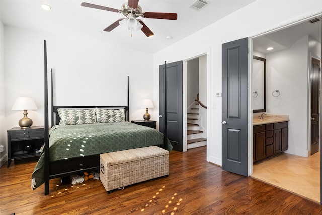 bedroom with ensuite bath, ceiling fan, sink, and dark hardwood / wood-style floors