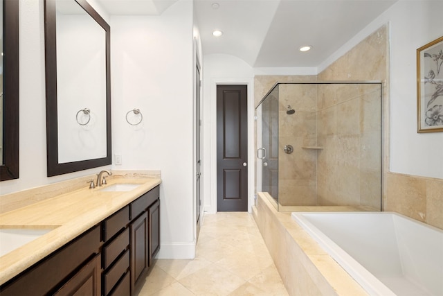 bathroom featuring tile patterned floors, vanity, and shower with separate bathtub