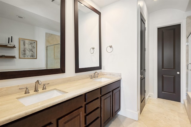 bathroom with tile patterned flooring, vanity, and a shower with shower door