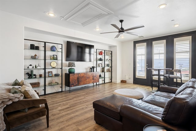 living room with wood-type flooring and ceiling fan