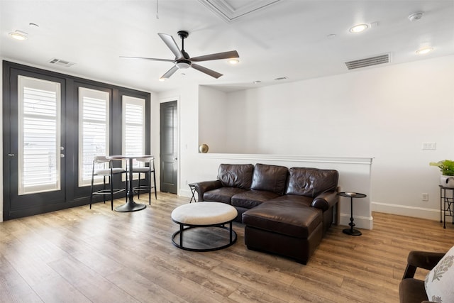 living room featuring hardwood / wood-style flooring and ceiling fan