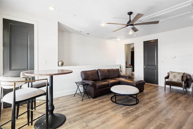 living room with ceiling fan and hardwood / wood-style floors