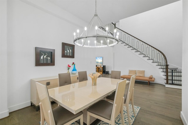 dining room with dark hardwood / wood-style floors and a chandelier