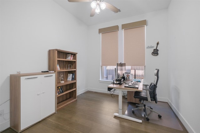 home office with ceiling fan and dark hardwood / wood-style flooring