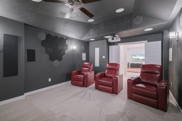 home theater featuring light colored carpet, vaulted ceiling, and ceiling fan