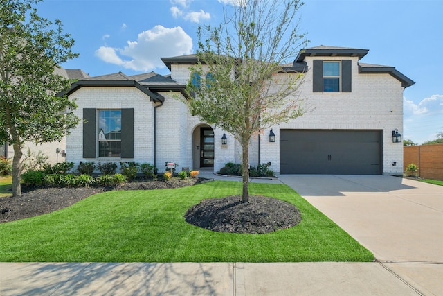 view of front of home with a front yard and a garage