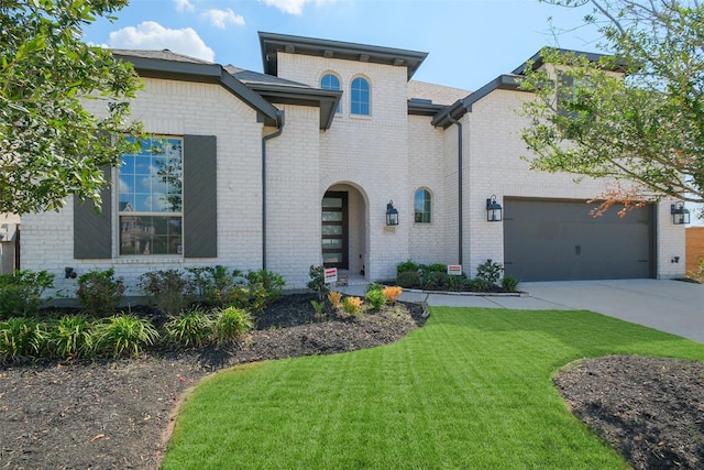 view of front of home featuring a garage and a front lawn