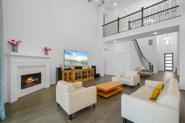 living room featuring dark hardwood / wood-style floors and a towering ceiling