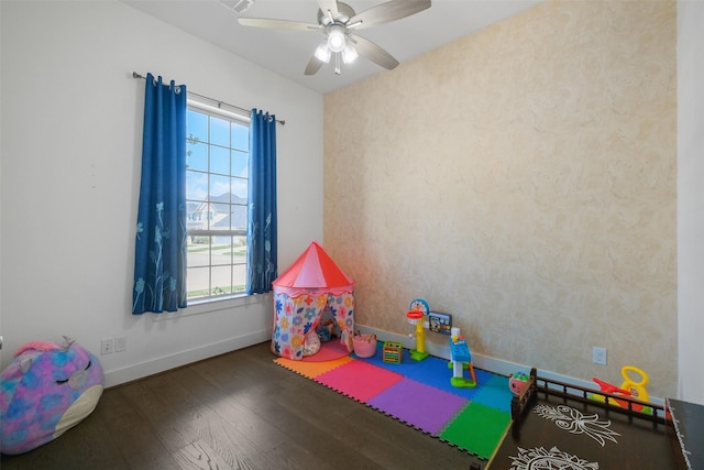 recreation room with ceiling fan and dark hardwood / wood-style floors