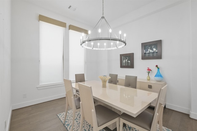 dining space with a notable chandelier and wood-type flooring