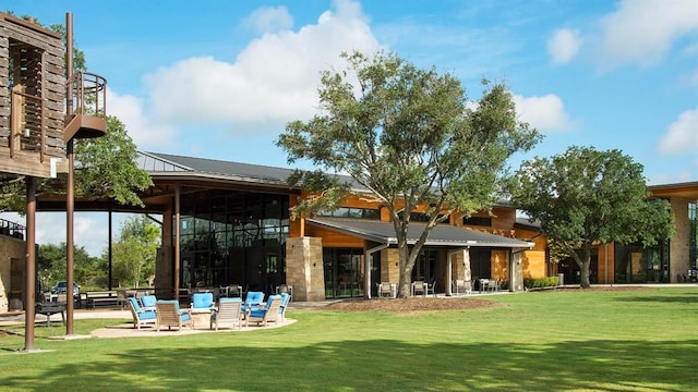 view of home's community featuring a yard and a patio