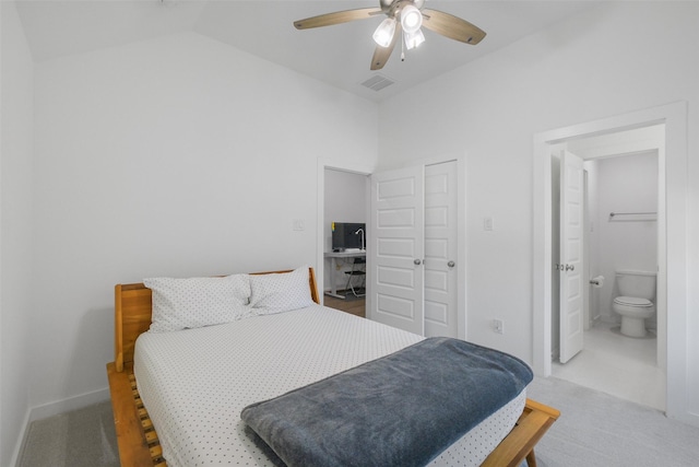 bedroom featuring carpet flooring, ensuite bath, ceiling fan, vaulted ceiling, and a closet