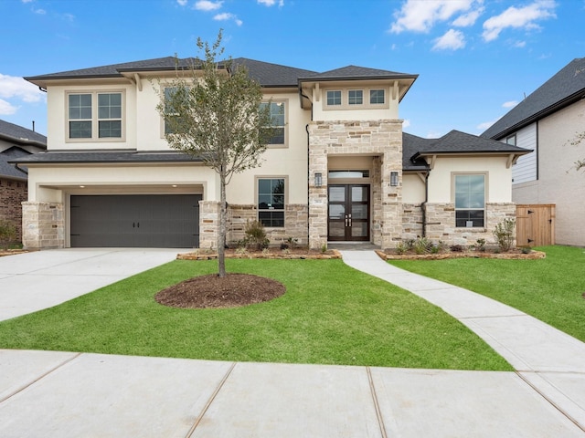 view of front of home with a front lawn, a garage, and french doors