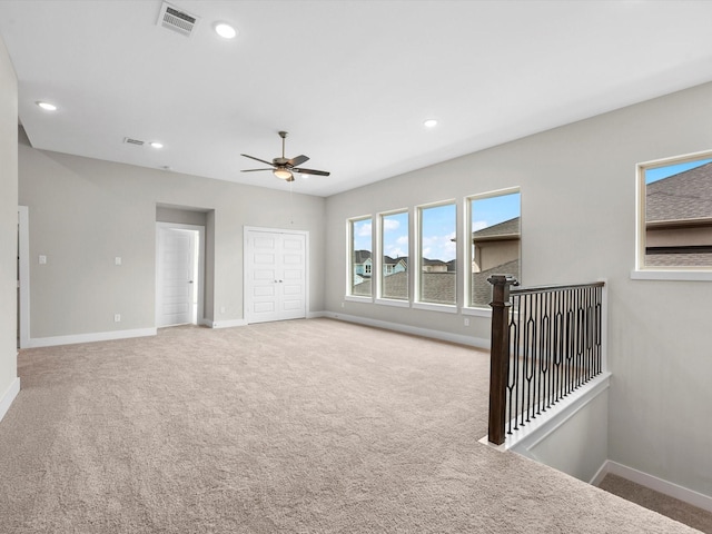 empty room with carpet flooring and ceiling fan