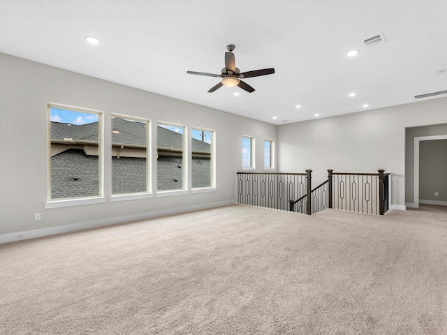 empty room with ceiling fan and light colored carpet