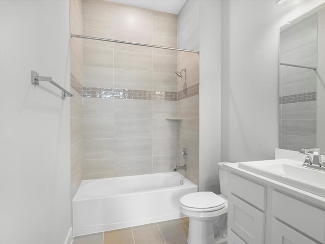 full bathroom featuring tile patterned flooring, vanity, tiled shower / bath combo, and toilet