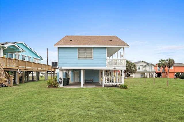 4406 Pabst Rd, Galveston, TX 77554 - rear view of house with stairway, a yard, a patio, and a shingled roof