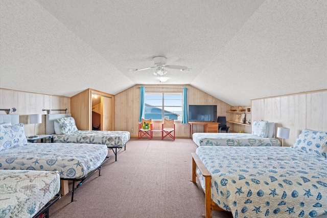 bedroom featuring ceiling fan, wood walls, light colored carpet, vaulted ceiling, and a textured ceiling