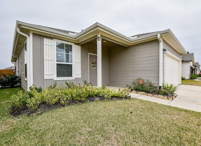 single story home featuring a garage and a front yard