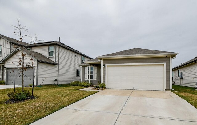 view of front of home with a front lawn and a garage