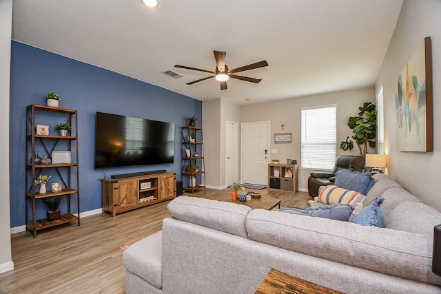 living room featuring ceiling fan and hardwood / wood-style flooring