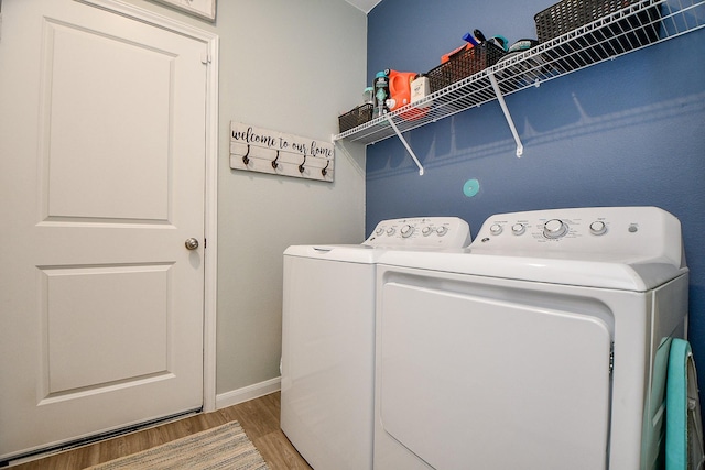 laundry area featuring hardwood / wood-style floors and independent washer and dryer