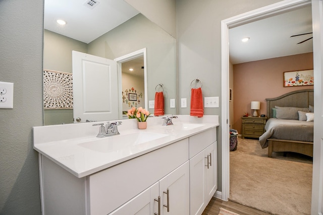 bathroom with ceiling fan and vanity