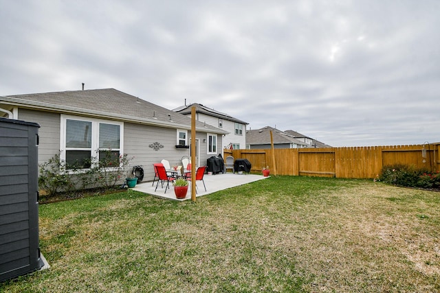 rear view of house with a yard and a patio area