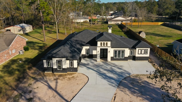 exterior space featuring a front lawn and french doors