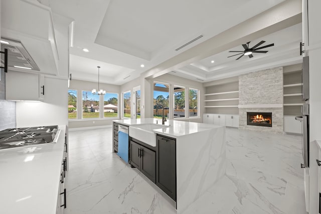 kitchen featuring hanging light fixtures, white cabinetry, appliances with stainless steel finishes, and a tray ceiling