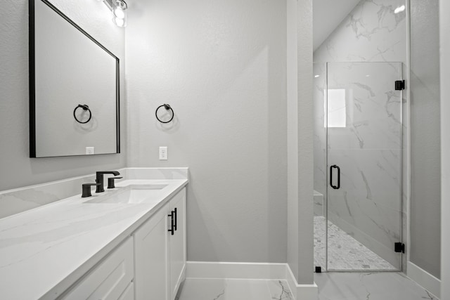 bathroom featuring a shower with door and vanity