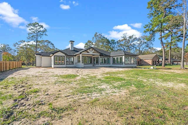 back of house featuring a lawn