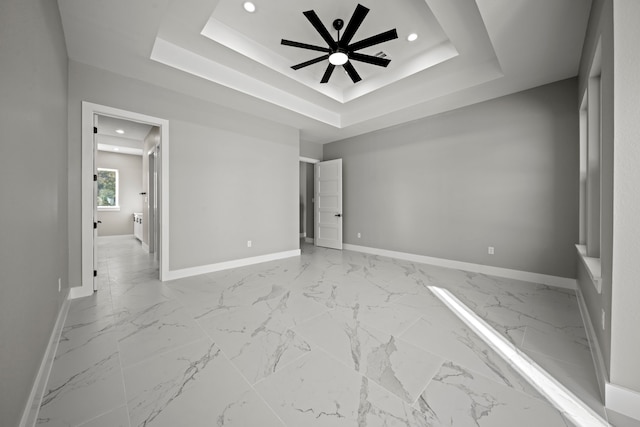 unfurnished bedroom with a tray ceiling