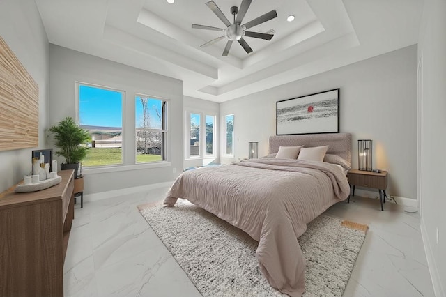 bedroom featuring a tray ceiling and ceiling fan