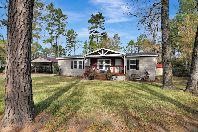 view of front of home with a carport, a porch, and a front yard