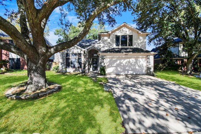 view of front facade with a garage and a front lawn