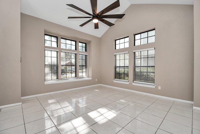 tiled empty room with high vaulted ceiling and ceiling fan